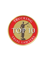 A circular badge with the text "TRUCKING TOP 10 TRIAL LAWYERS" around an image of Lady Justice holding scales.