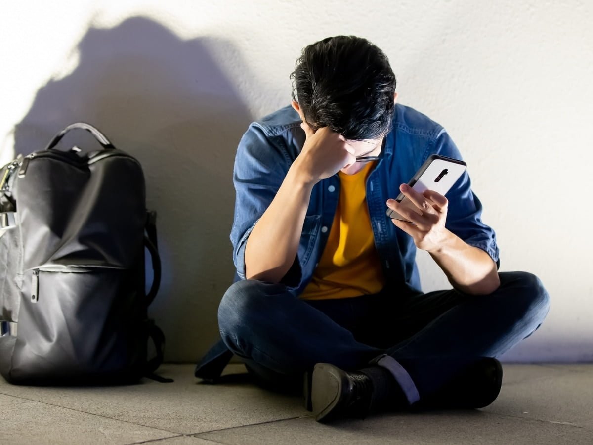 Boy Sitting Looking At His Phone | Personal Injury Attorney | Andy Citrin