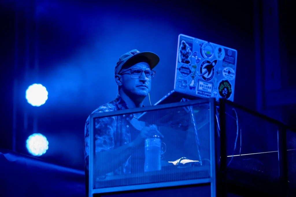 DJ on Stage Looking at Laptop