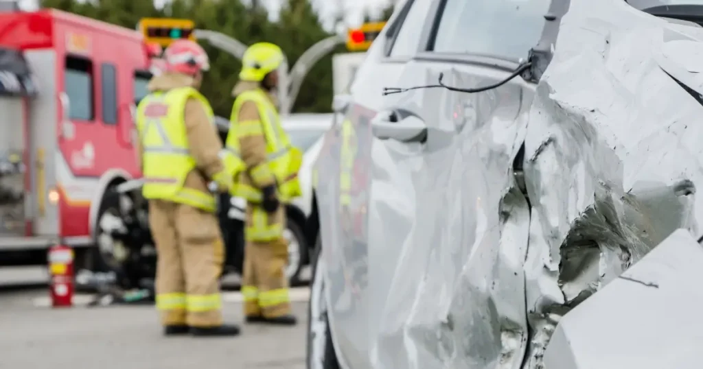 side-damaged vehicle - firefighters on scene